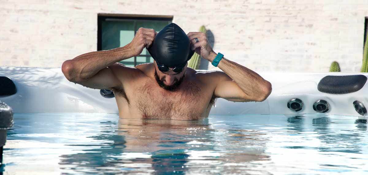 Phelps putting on a swimming cap.