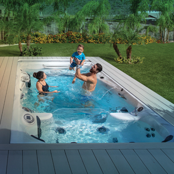 Michael, Nicole and Boomer Phelps enjoying time together in a swim spa.