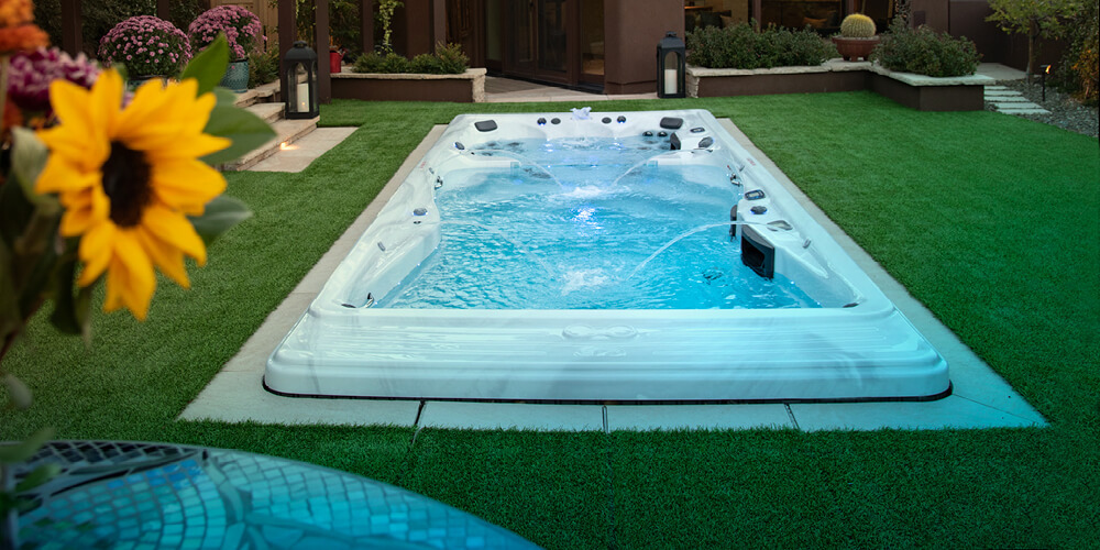 A swim spa set in the ground.