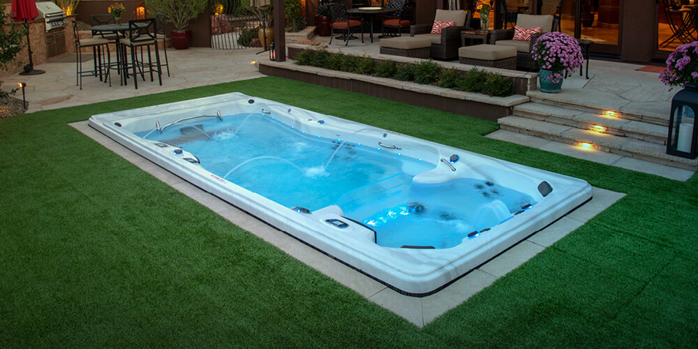 A swim spa set in the ground.